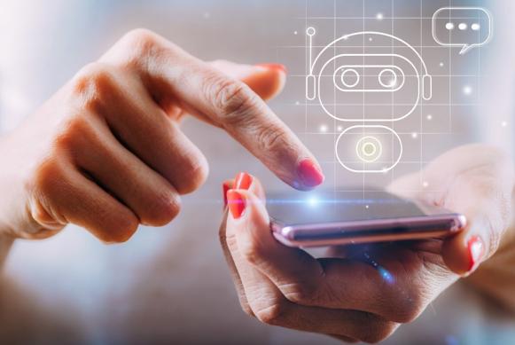 Imagen de manos de una mujer manipulando un celular con su dedo indice dónde se proyecta una imagen holográfica de un robot de inteligencia artificial. Imagen de manos de una mujer manipulando un celular con su dedo indice dónde se proyecta una imagen holográfica de un robot de inteligencia artificial.