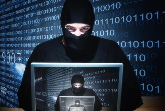 Imagen de hombre con capucha detrás de un computador que representa a un Ciberdelincuente/ Fuente: Revista Portafolio. Imagen de hombre con capucha detrás de un computador que representa a un Ciberdelincuente/ Fuente: Revista Portafolio.